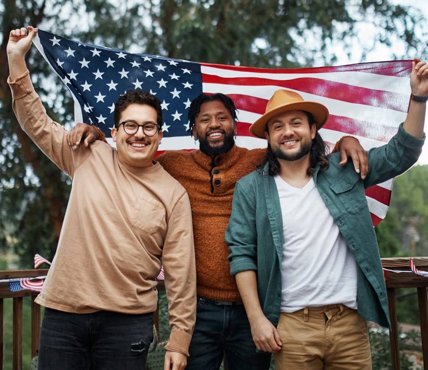 Friends holding American flag outdoors